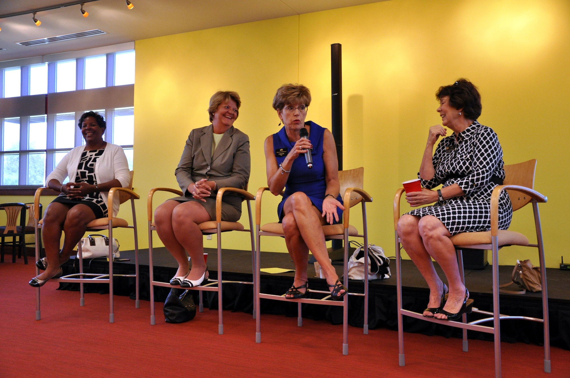 Cathy Noon, mayor of the City of Centennial, speaks at the Women's Professional Panel as Lisa Buckley, Mary Chelsey, and Su Ryden listen on Aug. 28 at the Panther Den on Buckley Air Force Base, Colo. The Women's Professional Panel was an opportunity for local professional women to offer life and career advice. (U.S. Air Force photo by Staff Sgt. Sabrina Moore/Released)