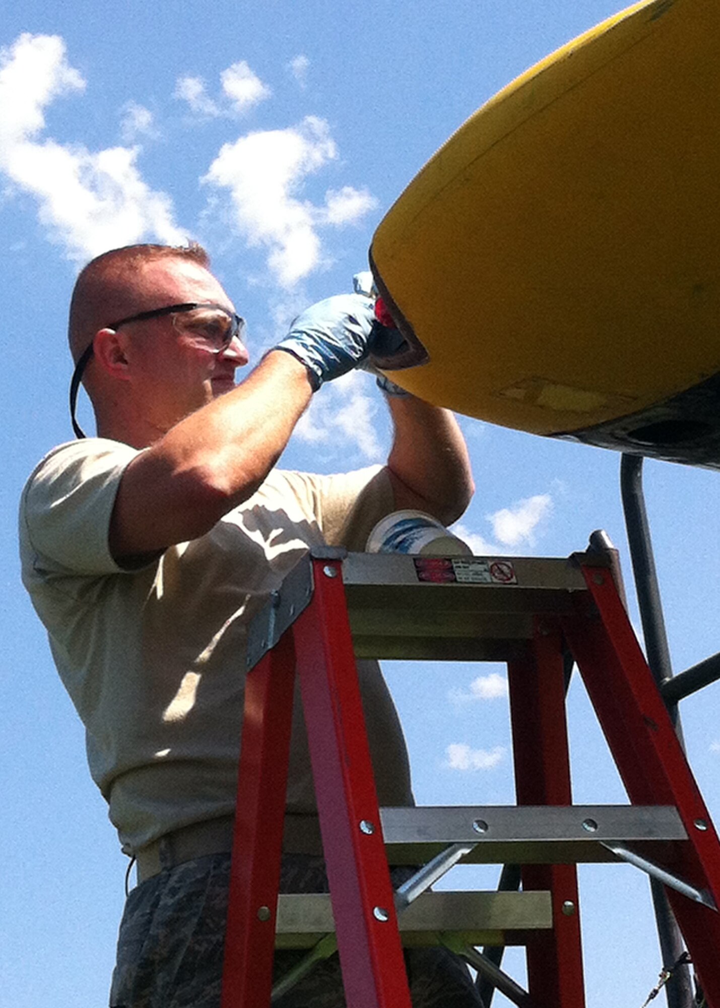 Master Sgt. Rodney Martin, 92nd Air Refueling Wing Historical Property Custodian, demonstrates a fiberglass repair of the left wingtip. (Courtesy Photo)
