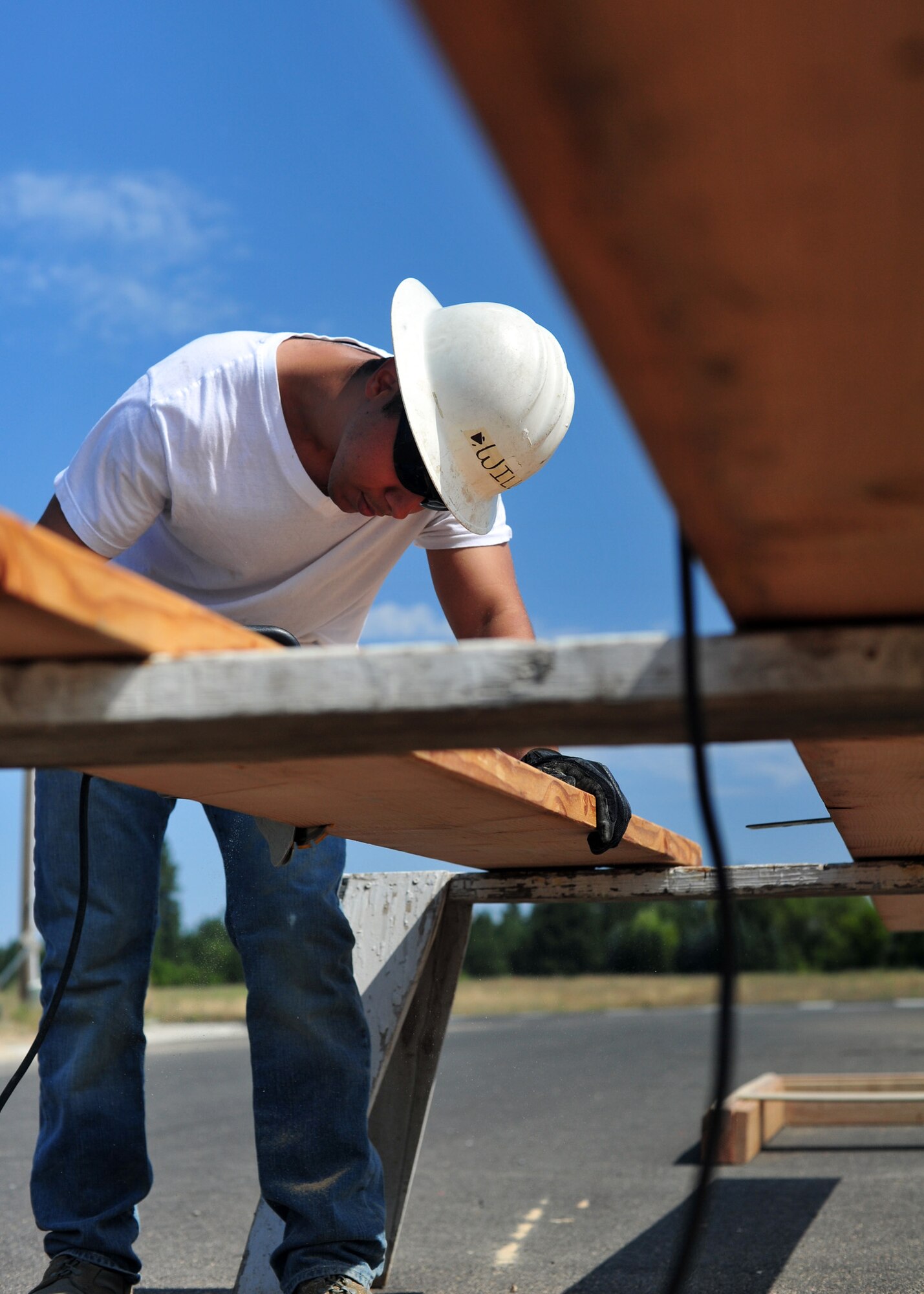 Senior Airman Will Hester, member of the Rock Airman Club, uses the circular saw to cut wood during a Habitat for Humanity home-building project at Deer Park, Wash., Aug. 24, 2013. The club is an event-based, Airman community-building outreach of the base chapel. (U.S. Air Force photo by Senior Airman Taylor Curry/Released)