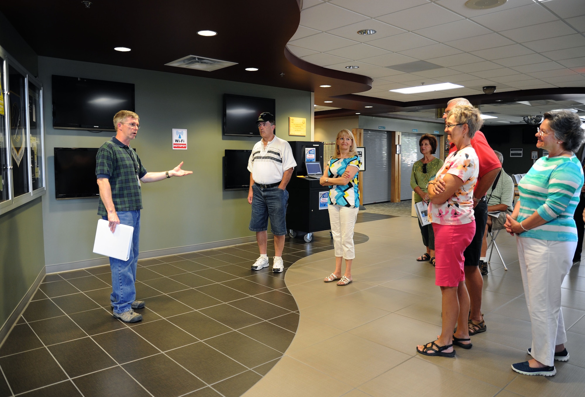 Mr. Terrance Douglas, 92nd Medical Support Squadron facility manager, speaks with prior service about the history of the 92nd Medical Group clinic during a tour at Fairchild Air Force Base, Wash., Aug. 31, 2013. The tour included stops at the Survival, Evasion, Resistance and Escape School, clinic and Heritage Air Park. (U.S. Air Force photo by Airman 1st Class Janelle Patiño/Released)