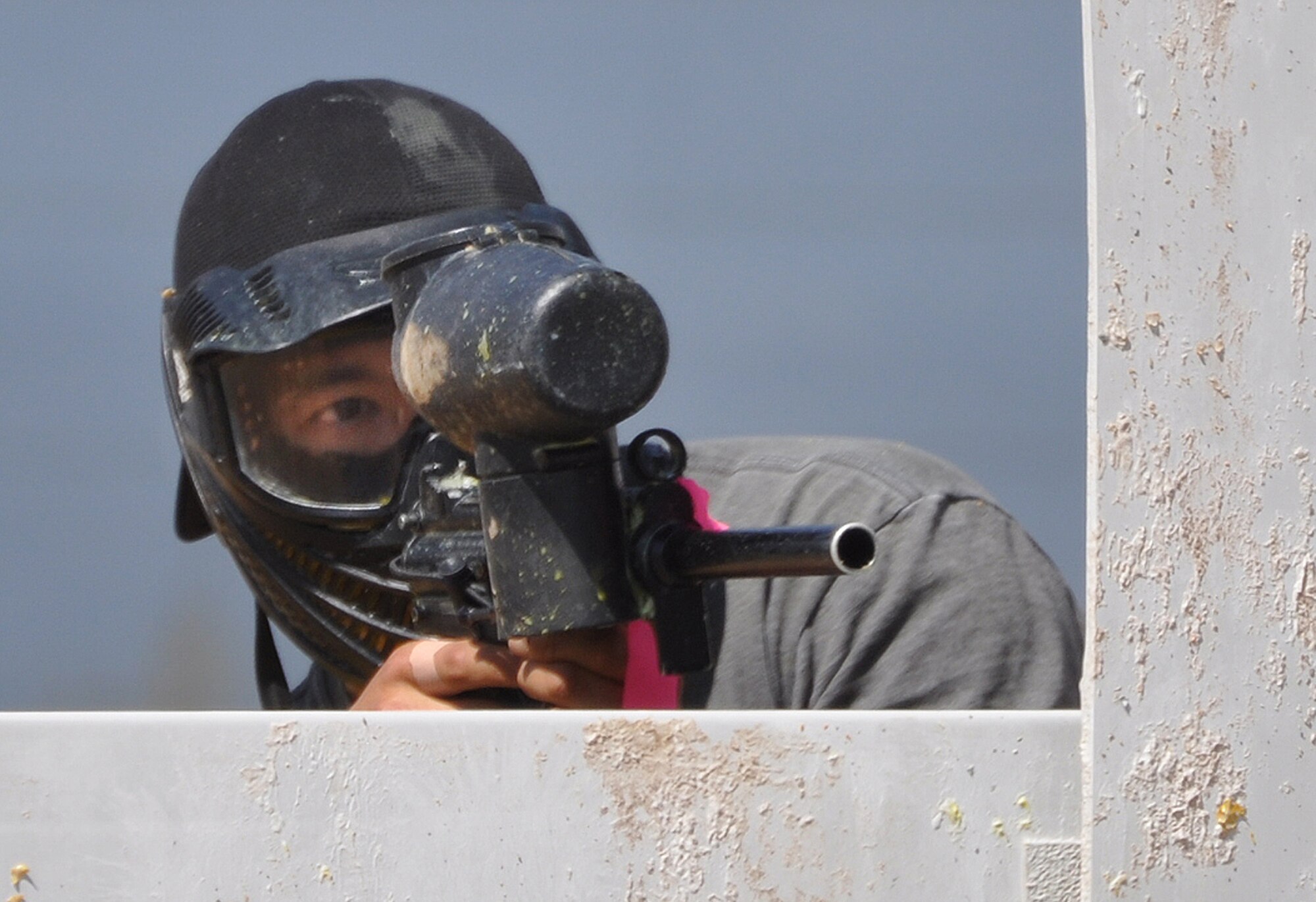 130831-F-GZ967-030 2nd Lt. Dan Cook, 90th Civil Engineer Squadron, uses a barricade to protect himself and to prevent the enemy team from advancing down one side of the field during a paintball match Aug. 31, 2013. Cook was part of a group of Airmen who traveled to Northern Colorado to spend the day paintballing. (U.S. Air Force photo by Airman 1st Class Brandon Valle)