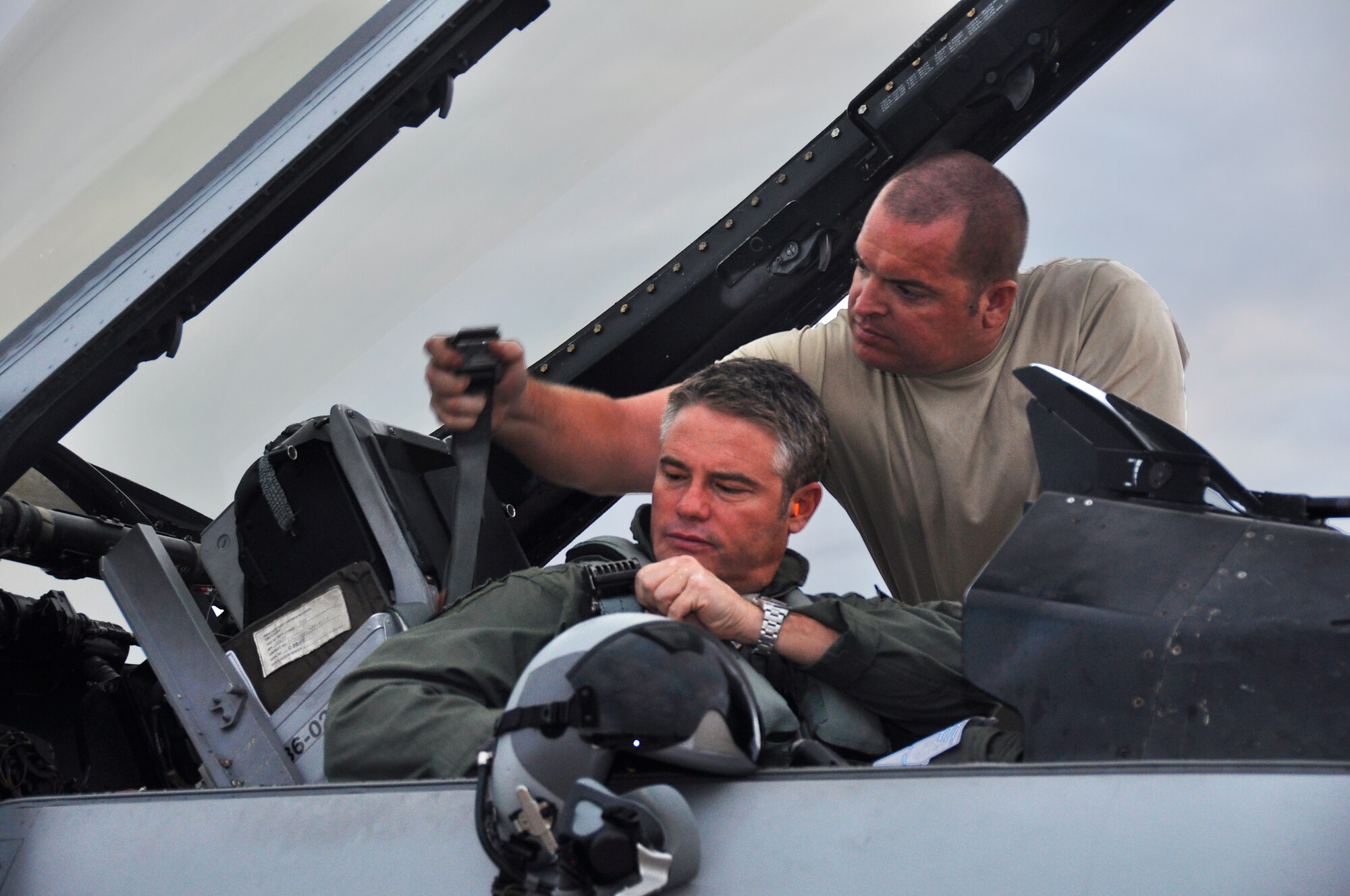 Lt. Col. Michael Hohman, Deputy Operations Group Commander for the 93rd Fighter  Squadron is assisted by Tech. Sgt. Martin Ballard, Detachment 93 crew chief, as he prepares to fly an F-16 during Operation Green Flag, Aug. 24. (U.S. Air Force Photo/ Tech. Sgt. Lou Burton)