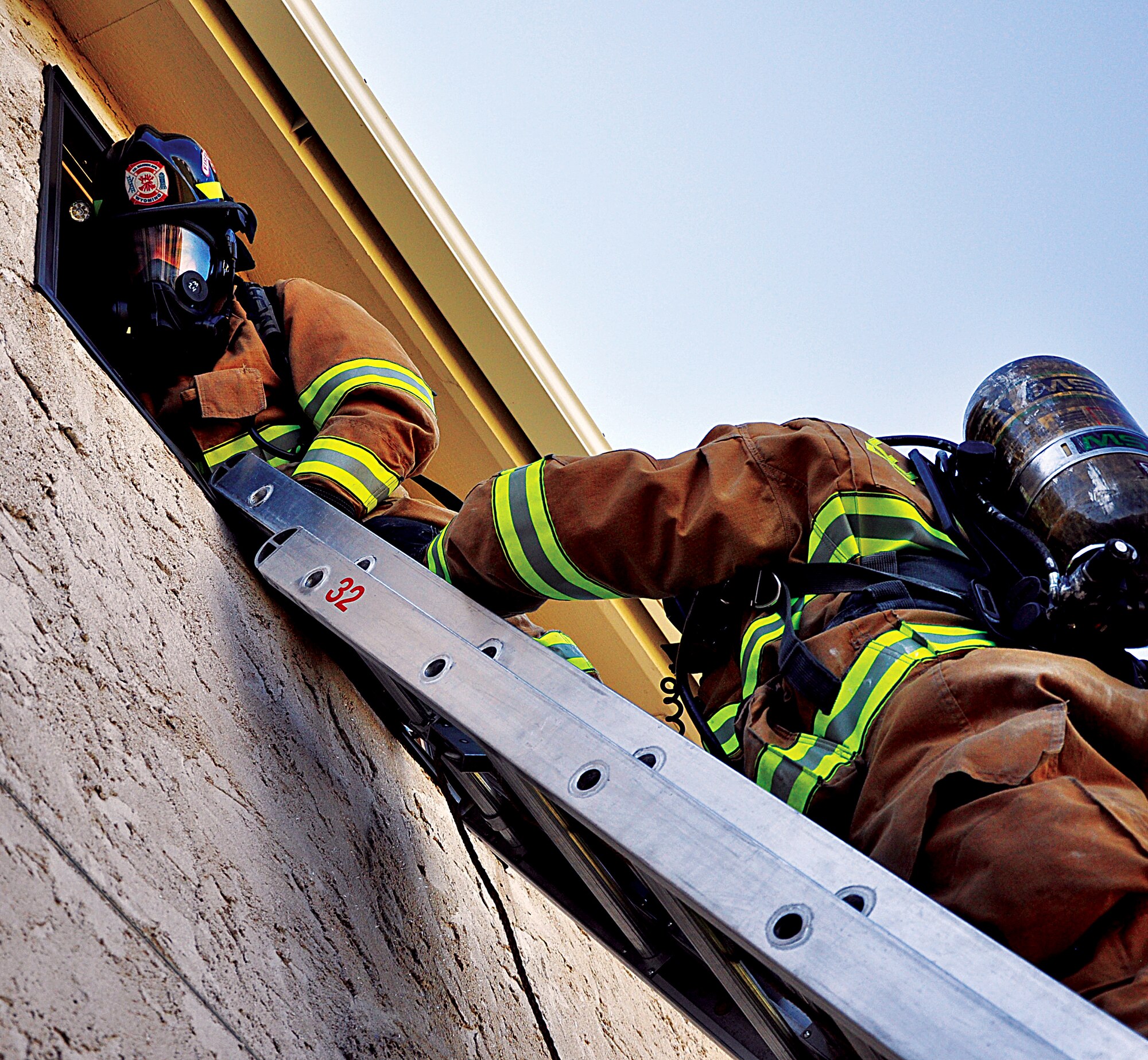 130829-F-DY381-056
Airmen 1st Class Nicholas Meno, above left, and Matthew Anderson, 90th Civil Engineer Fire Department firefighters, exit a house after performing a window rescue Aug. 29, 2013, during a week-long joint training exercise with the Cheyenne, Wyo., fire department. A window rescue consists of breeching a window, firefighters climbing into the building through the breeched window, retrieving the individuals/animals trapped inside and then returning through the window to the outside. (U.S. Air Force photo by Senior Airman Mike Tryon)
