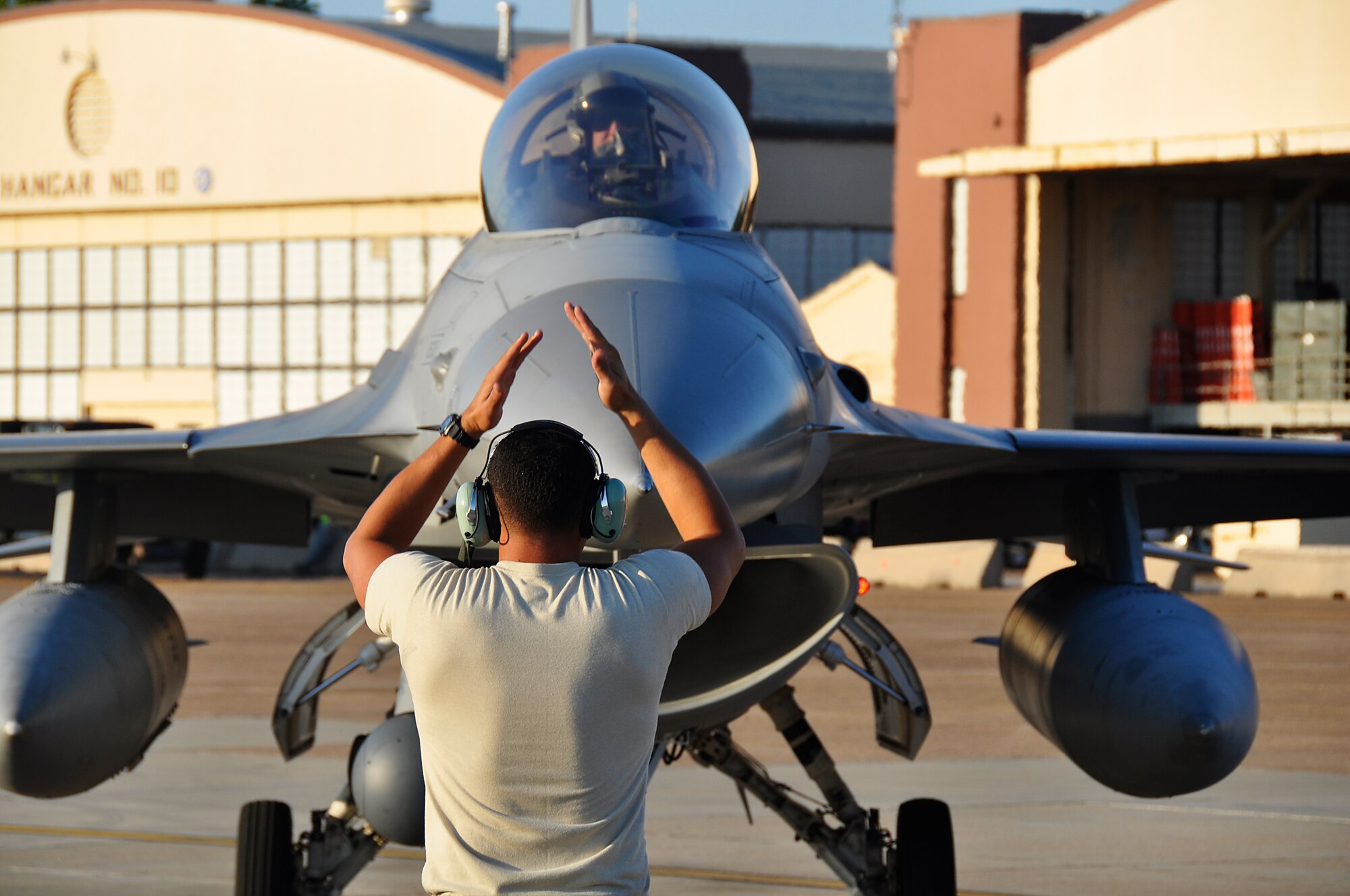 Tech. Sgt. Jose Quinones, 482nd Fighter Wing crew chief, recovers an F-16 fighter jet from Lt. Col. Sean Gustafson, 93rd fighter pilot, during Operation Green Flag at Barksdale Air Force Base, LA. Aug. 26. One hundred and sixty two Airmen participated in the joint exercise aimed at training tactical operations to approximately 5,000 Army ground forces. (U.S. Air Force Photo/ Tech. Sgt. Lou Burton)