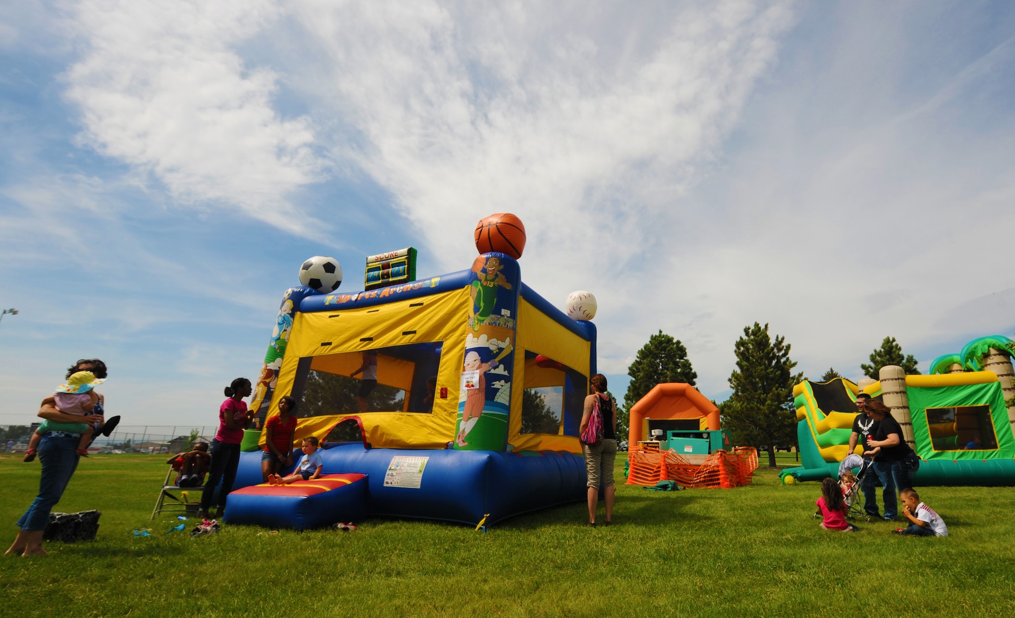 Children jump in party inflatable attractions during the base picnic at the Bellamy Fitness Center on Ellsworth Air Force Base, S.D., Aug. 23, 2013. Airmen and families participated in a wide variety of activities throughout the day to include a mash endurance competition, Eagles vs. Chiefs softball game, and face painting all done as a way to build morale. (U.S. Air Force photo by Airman 1st Class Rebecca Imwalle/Released)