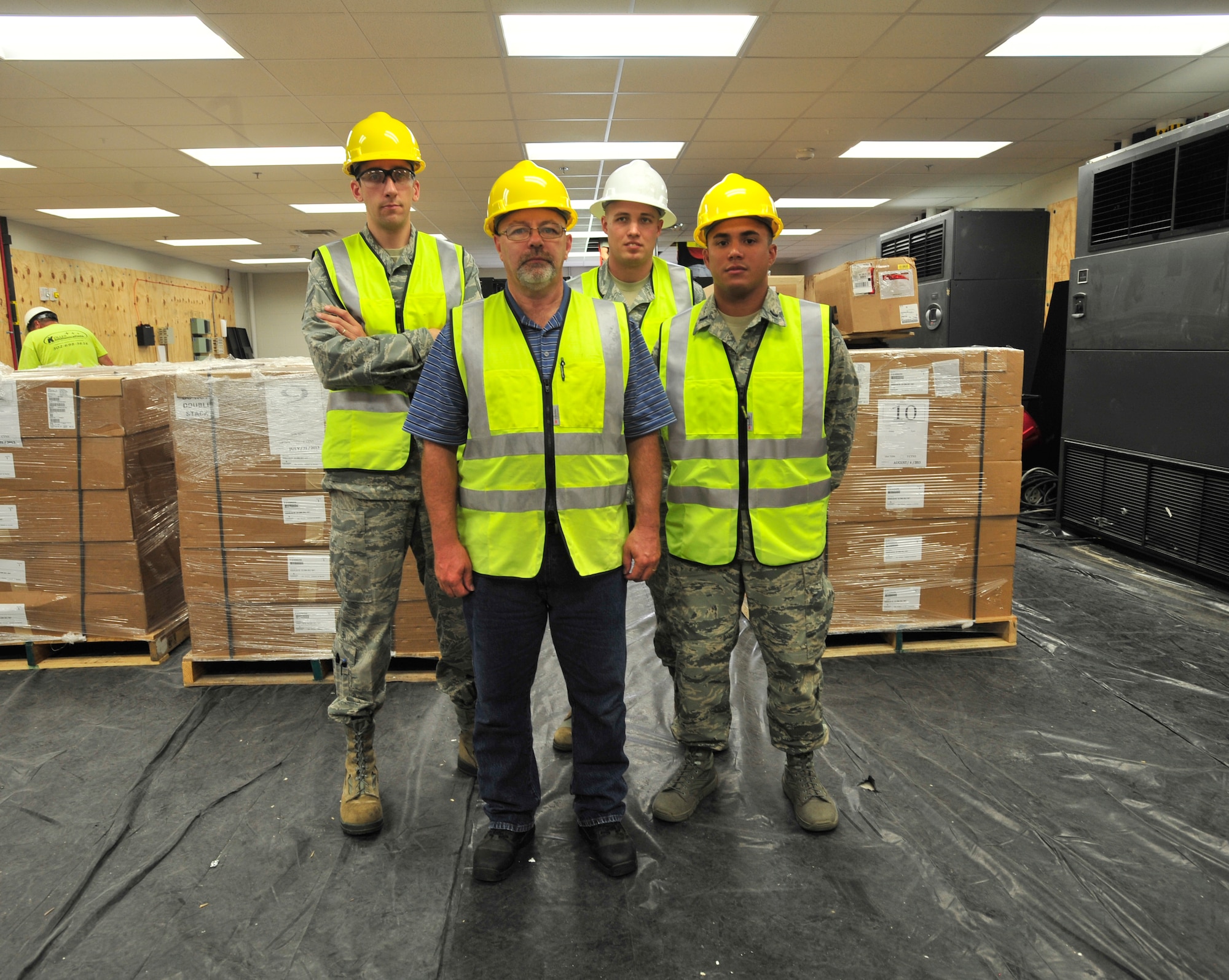 Members of the 436th Communications Squadron plans and programs team stand in the new 436th CS building Aug. 28, 2013, at Dover Air Force Base, Del. The plans and programs team was selected to represent the Air Mobility Command in the 2013 Department of Defense Chief Information Officer awards. (U.S. Air Force photo/Staff Sgt. Elizabeth Morris)