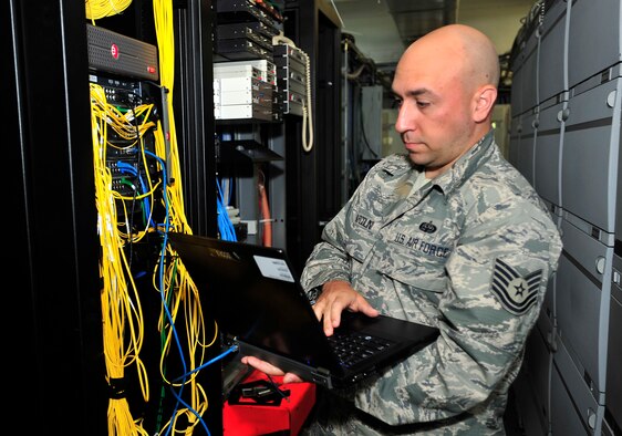 Tech. Sgt. Jeremy Marcolini, 436th Communications Squadron Cyber Transport Systems NCOIC, transfers a switch Aug. 28, 2013, at Dover Air Force Base, Del. Marcolini was selected to represent the Air Mobility Command in the 2013 Department of Defense Chief Information Officer awards. (U.S. Air Force photo/Staff Sgt. Elizabeth Morris)