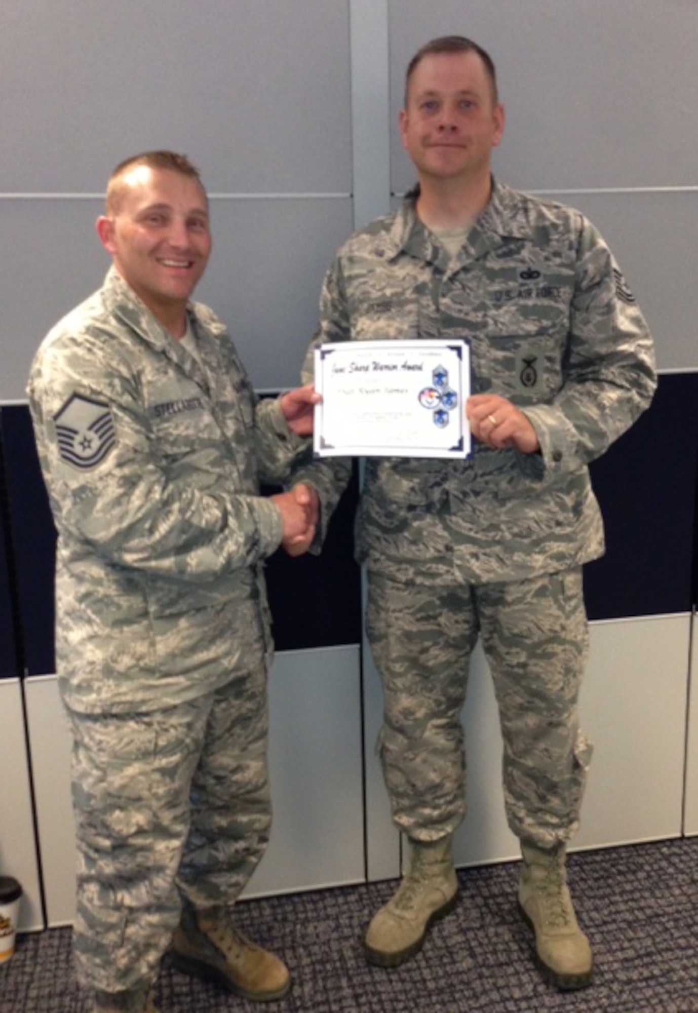 SCHRIEVER AIR FORCE BASE, Colo. – Master Sgt. Dan Stellabotte, on behalf of the Pikes Peak Top 3, presents the June Sharp Warrior Award to Tech. Sgt. Ryan James, 50th Security Forces Squadron at Schriever AFB. James set up a 1-on-1 qualification session so an Airman could qualify and deploy the next day. By professionally exceeding expectations in preparing the Airman, James was selected as the Sharp Warrior recipient. (U.S. Air Force photo)
