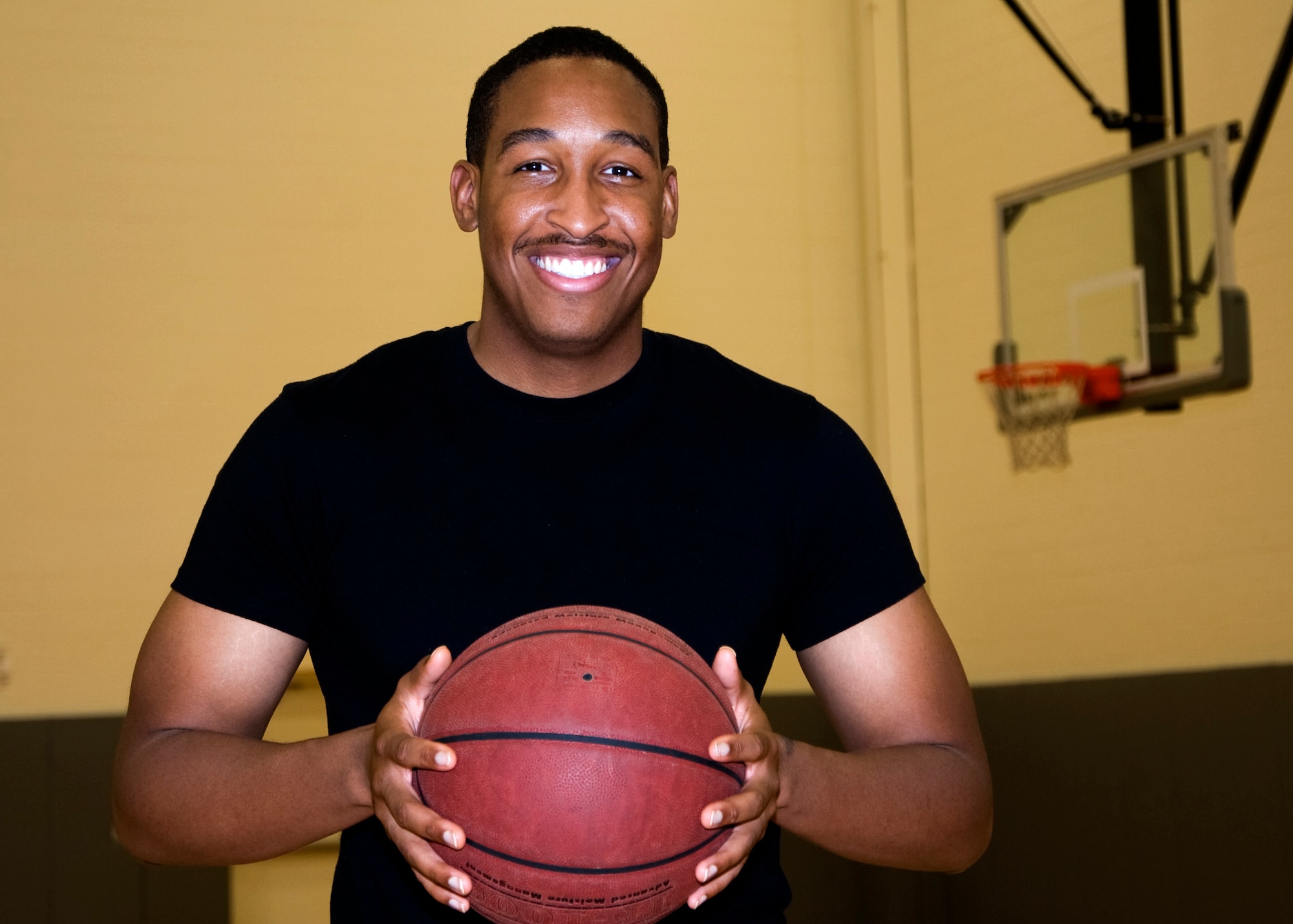 Senior Airman Delvin Darien, 436th Medical Group occupational health technician, shows enthusiasm before playing a game of basketball Aug. 23, 2013, at the base gym on Dover Air Force Base, Del. Darien was recognized by his leadership as Team Dover’s Airman of the Month because of his hard work and self-motivation. (U.S. Air Force photo/Senior Airman Jared Duhon)