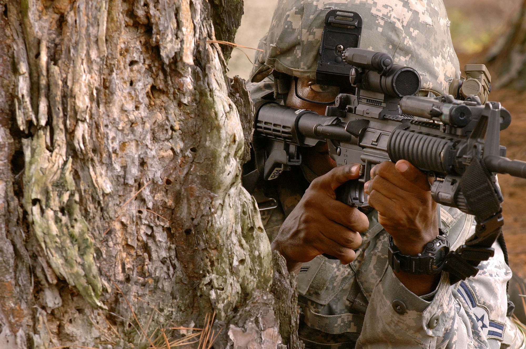 U.S. Air Force Airman 1st Class Wendell McLellan, 4th Security Forces Squadron defender, secures the perimeter during an exercise at Seymour Johnson Air Force Base, N.C., Aug. 25, 2013.  The team followed a map into the woods to find a simulated weapons cache as part of their training.  (U.S. Air Force photo by Airman 1st Class Brittain Crolley/Released)