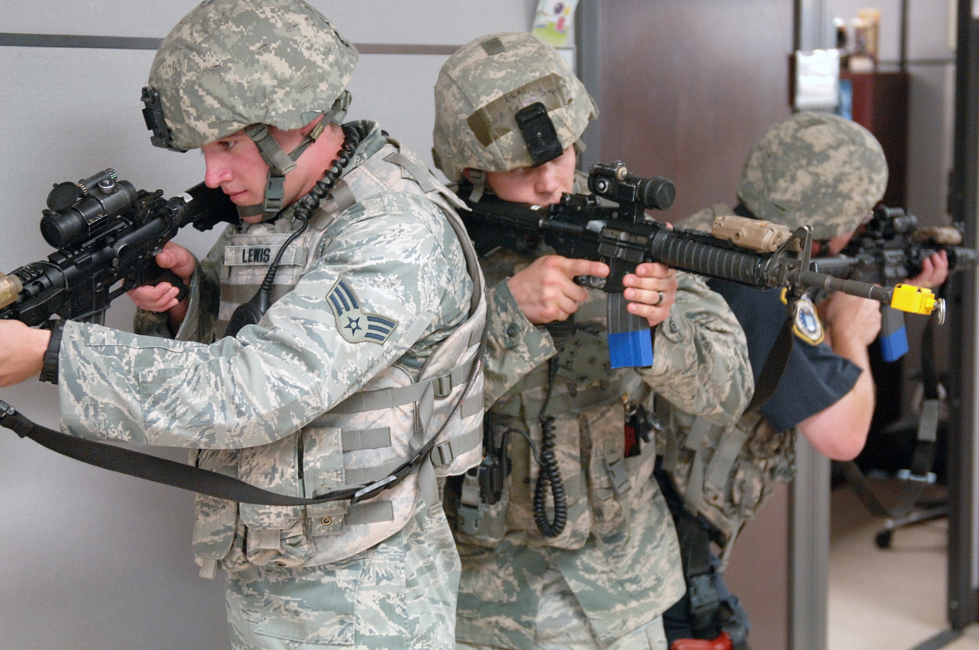 U.S. Air Force Senior Airmen Conner Lewis and Leland Soper along with Bernard Listeman, 4th Security Forces Squadron defenders, clear a building during an active shooter exercise at Seymour Johnson Air Force Base, N.C., Aug. 24, 2013.  The three-man team was the first on scene during the scenario.  (U.S. Air Force photo by Airman 1st Class Brittain Crolley/Released)