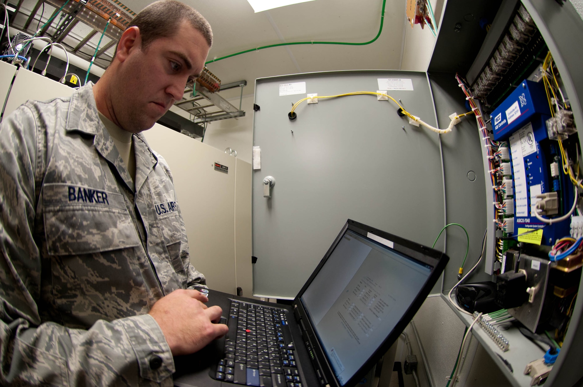 Staff Sgt. Robert Banker, 28th Communications Squadron ground radar maintenance technician, uses special computer software to inspect an air conditioning system at the radar tower in Box Elder, S.D., Aug. 27, 2013. The air conditioning systems are responsible for keeping the $3.5 million  Digital Airport Surveillance Radar systems from overheating. (U.S. Air Force photo by Airman 1st Class Zachary Hada/Released)