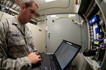 Staff Sgt. Robert Banker, 28th Communications Squadron ground radar maintenance technician, uses special computer software to inspect an air conditioning system at the radar tower in Box Elder, S.D., Aug. 27, 2013. The air conditioning systems are responsible for keeping the $3.5 million  Digital Airport Surveillance Radar systems from overheating. (U.S. Air Force photo by Airman 1st Class Zachary Hada/Released)