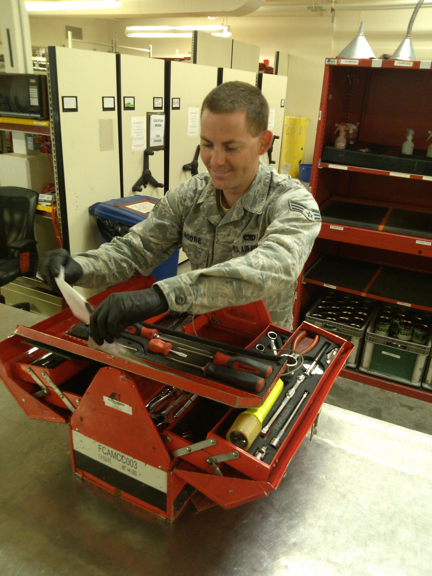 Senior Airman Christopher Moore, 92nd Aircraft Maintenance Squadron sortie support section member, works with his tool kit at Fairchild Air Force Base, Wash., Aug. 7, 2013.  Moore has been selected as Fairchild's Finest.  (Courtesy photo)