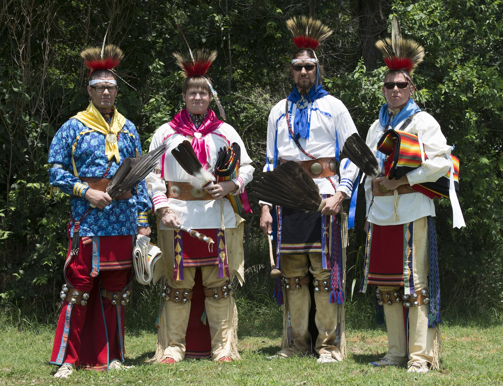 Osage Nation relatives of Maj. Gen. Clarence L. Tinker, dressed in native attire, sing and dance to a song written to Tinker during their annual four day celebration called In-lon-shka held in Pawhuska Indian Village, Okla., June 30, 2013. Tinker was the highest ranking officer of Native-American ancestry and the first general lost in action during World War II.