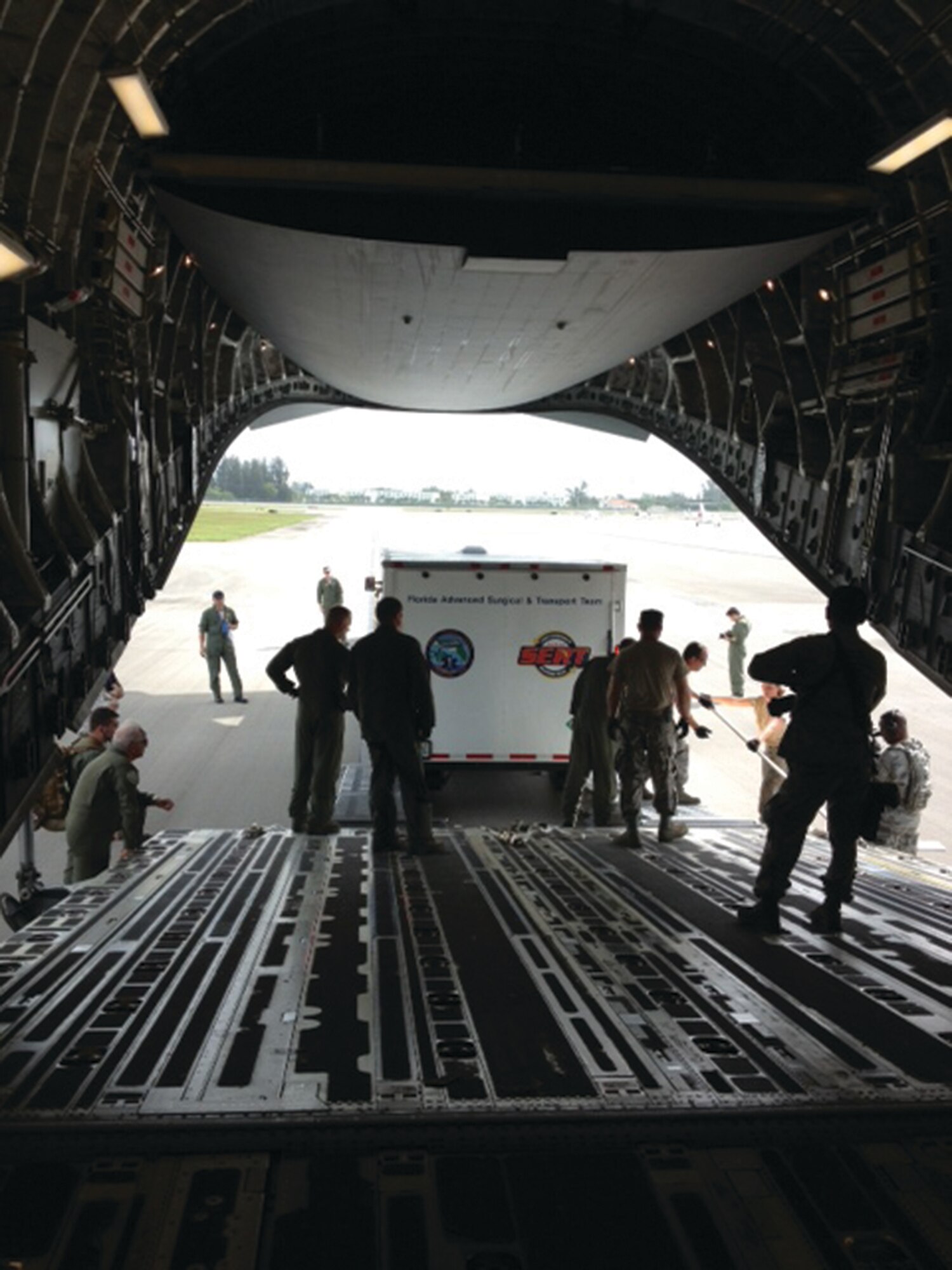 WRIGHT-PATTERSON AIR FORCE BASE, Ohio - A trailer belonging to the Florida Advanced Surgical and Transport Team is off-loaded from a 445th Airlift Wing C-17 Globemaster III at Fort McCoy, Wis., July 26. The trailer along with the team’s personnel, equipment and truck were transported by the wing for Global Medic 2013. (Courtesy photo)