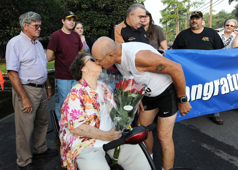 Retired U.S. Air Force Master Sgt. Joe Christian kisses his wife of 56 years, Marlene Christian, after completing the Flatlander 5K road race in Lakeland, Ga., Aug. 31, 2013. Christian worked in various Air Force specialties, including maintenance, hydraulics and engines. He was also one of the Air Force’s last enlisted pilots. (U.S. Air Force photo by Master Sgt. Sonny Cohrs/Released) 