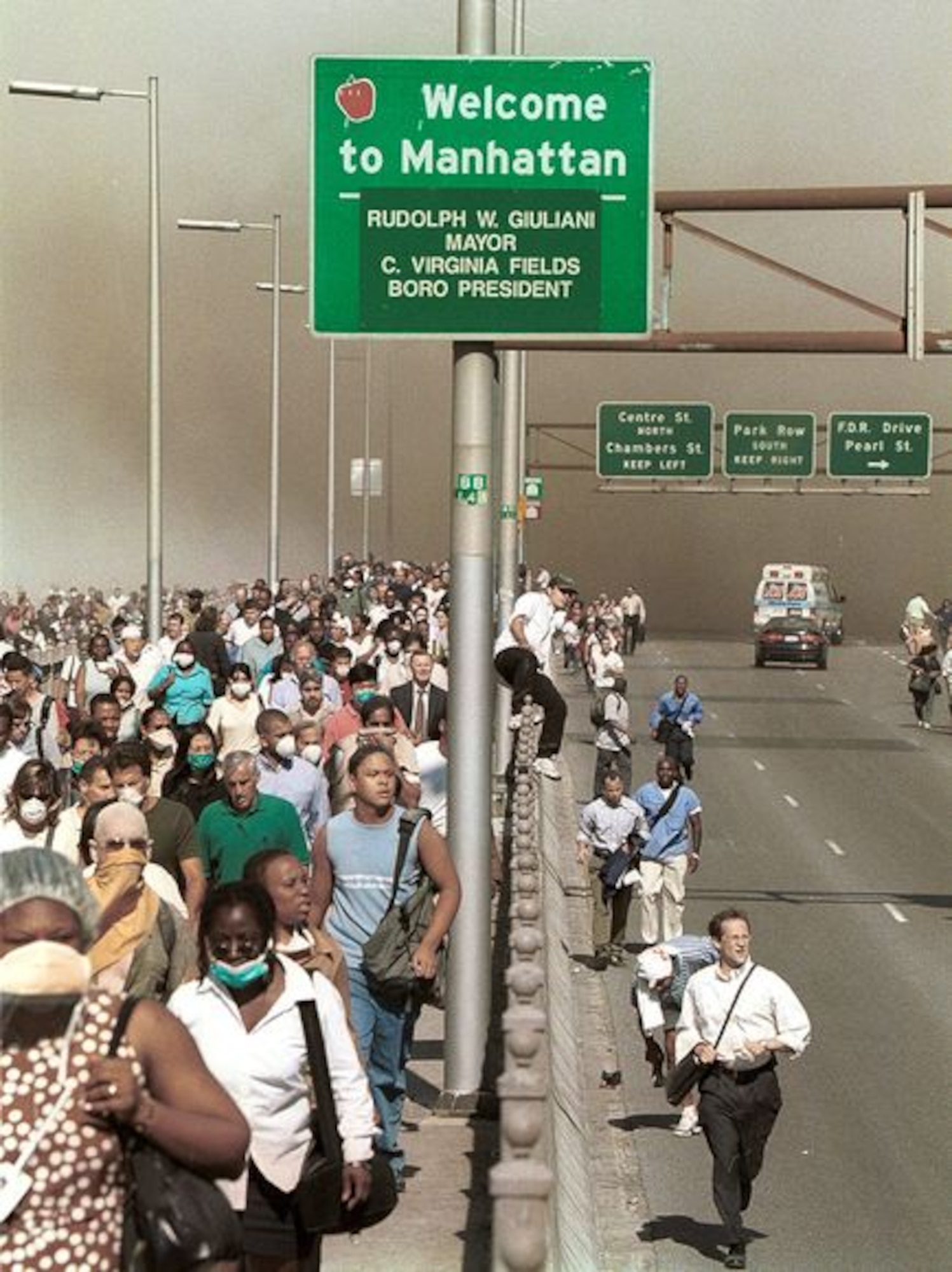 Residents and visitors flee Manhattan via the Brooklyn Bridge, after the Sept. 11, 2001 terrorist attack on the World Trade Center. Since public transportation was disabled, the people were forced to make a mass exodus through a smoky and chaotic city. (AP photo by Daniel Shanken/Released)