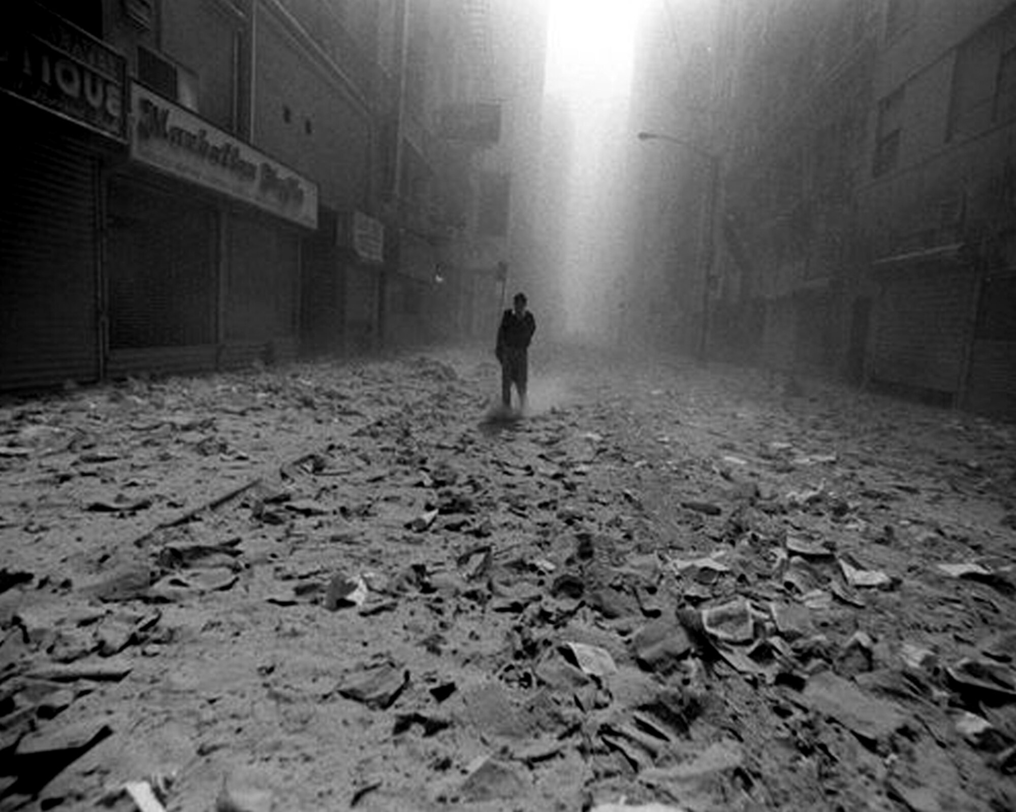 A lone person stands on a New York City Street after the World Trade Center collapse, Sept. 11, 2001. Practically the entire city of Manhattan was covered in a thick cloud of dust and ash as a result of the tower collapse. (Corbis photo by Jason Florio/Released)