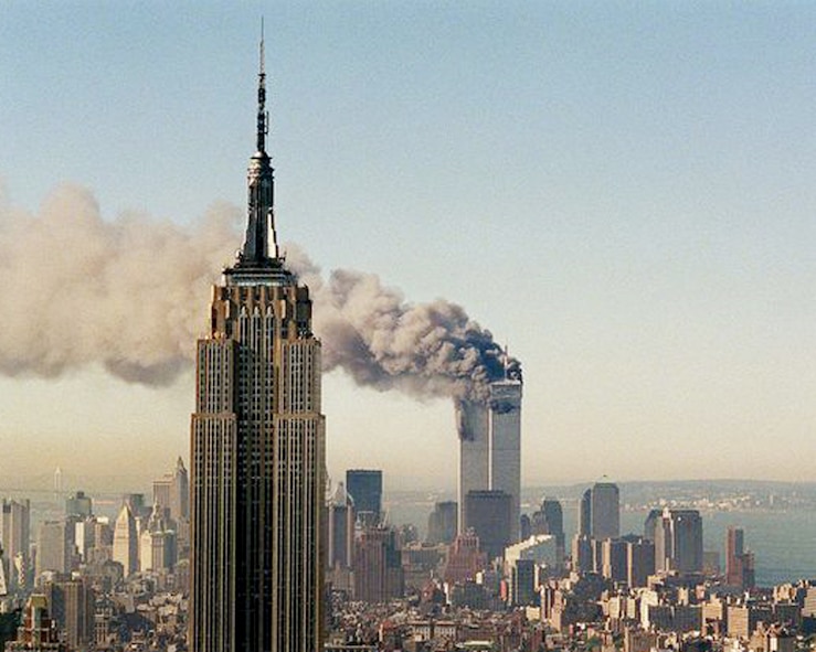 The World Trade Center burns behind New York City’s Empire State Building, Sept. 11, 2001. Both towers were attacked as a result of a highly-coordinated al-Qaida plot. (AP photo by Marty Lederhandler/Released)