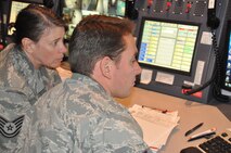 Tech. Sgt. Charlene Kapp trains Staff Sgt. Roy Varney in the command post in late August. The 916th Command Post is hiring for predicted future vacancies. (USAF photo by Maj. Erin Karl, 916ARW/PA)