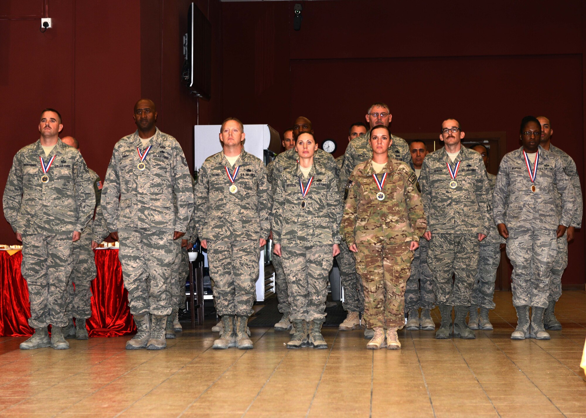 Master sergeant selects stand at attention prior to receiving certificates during the Senior NCO Induction Ceremony at the 379th Air Expeditionary Wing in Southwest Asia, Aug. 30, 2013. This year’s Air Force-wide theme for the ceremony was “The Next Generation of Leaders.” (U.S. Air Force photo/Senior Airman Bahja J. Jones) 