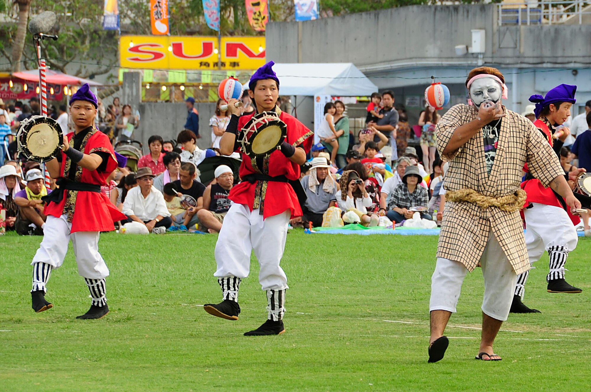 A Taiko drum group and chondara perform for the crowd during the 58th Okinawa Zento Eisa Festival in Koza Athletic Park Aug. 31, 2013. This island-wide event is the largest of its kind in Okinawa and lasts for three days. (U.S. Air Force photo by Staff Sgt. Darnell T. Cannady)