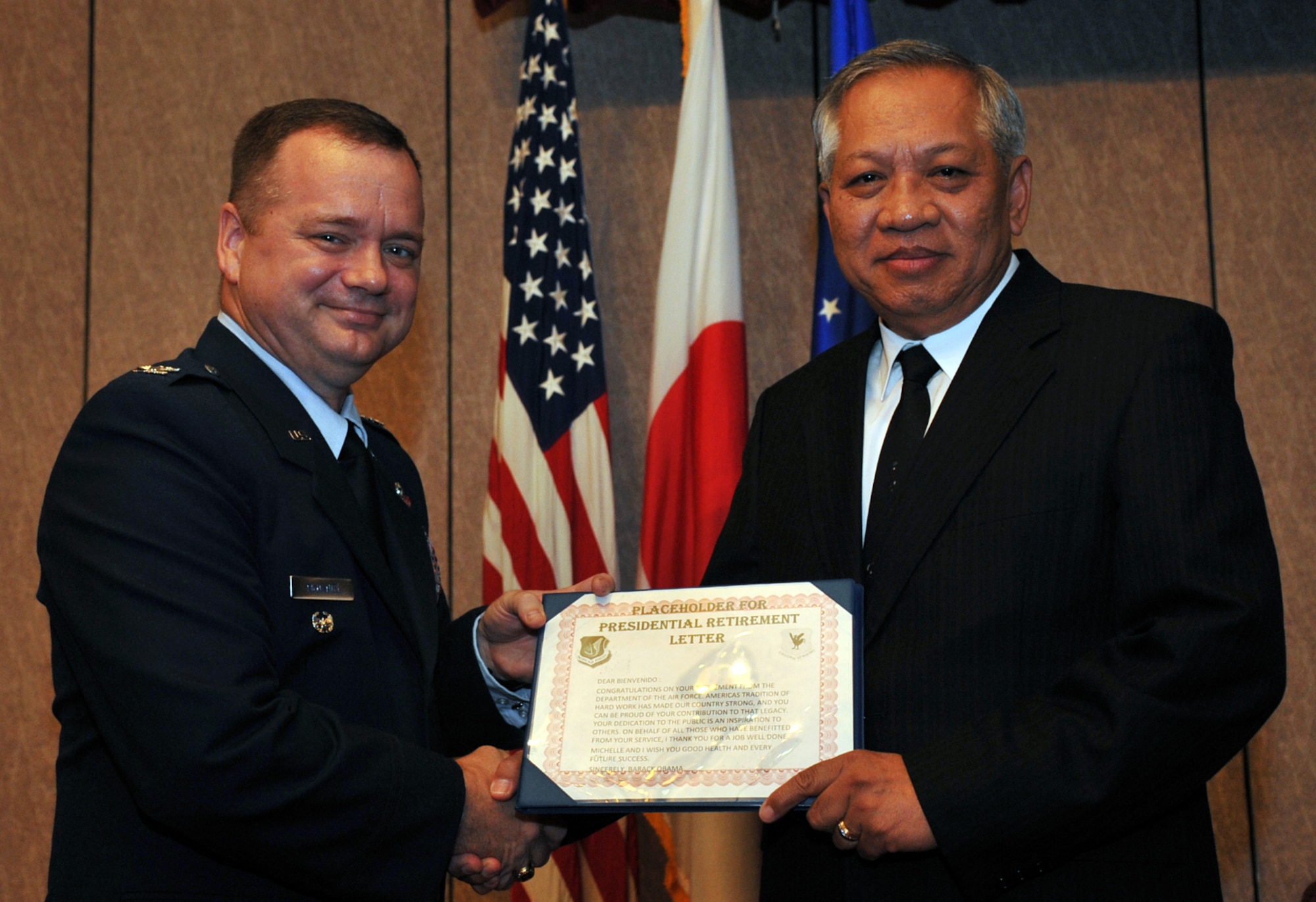 U.S. Air Force Col. Brian McDaniel, 18th Wing vice commander, awards Bienvenido Baluyot the presidential retirement letter during Baluyot’s retirement ceremony at the NCO Club on Kadena Air Base, Japan, Aug. 29, 2013. Baluyot was born in Manila, Republic of the Philippines, and served 23 years active duty Air Force. He retired in the grade of senior master sergeant, Apr. 1, 1992, at Robins Air Force Base, Ga., where he continued service as a government civilian. Baluyot served his country for more than 44 years. (U.S. Air Force photo by Naoto Anazawa)