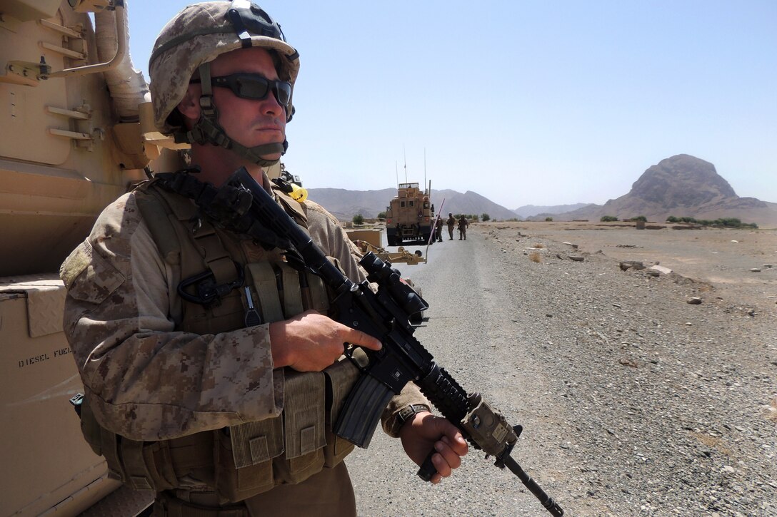 U.S. Navy Petty Officer 1st Class Jeremiah Shuemaker conducts a security halt during a convoy from Shindand to Camp Bastion, Helmand province, Afghanistan, Aug. 27, 2013. Shuemaker, a builder, is assigned to Naval Mobile Construction Battalion 15.