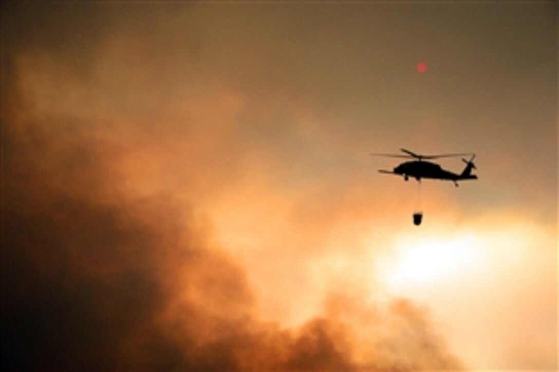 Airmen perform precision water bucket drops to support the Rim fire suppression operation at Tuolumne County near Yosemite National Park, Calif., Aug. 26, 2013. The guardsmen are assigned to the 129th Rescue Wing, California Air National Guard.
