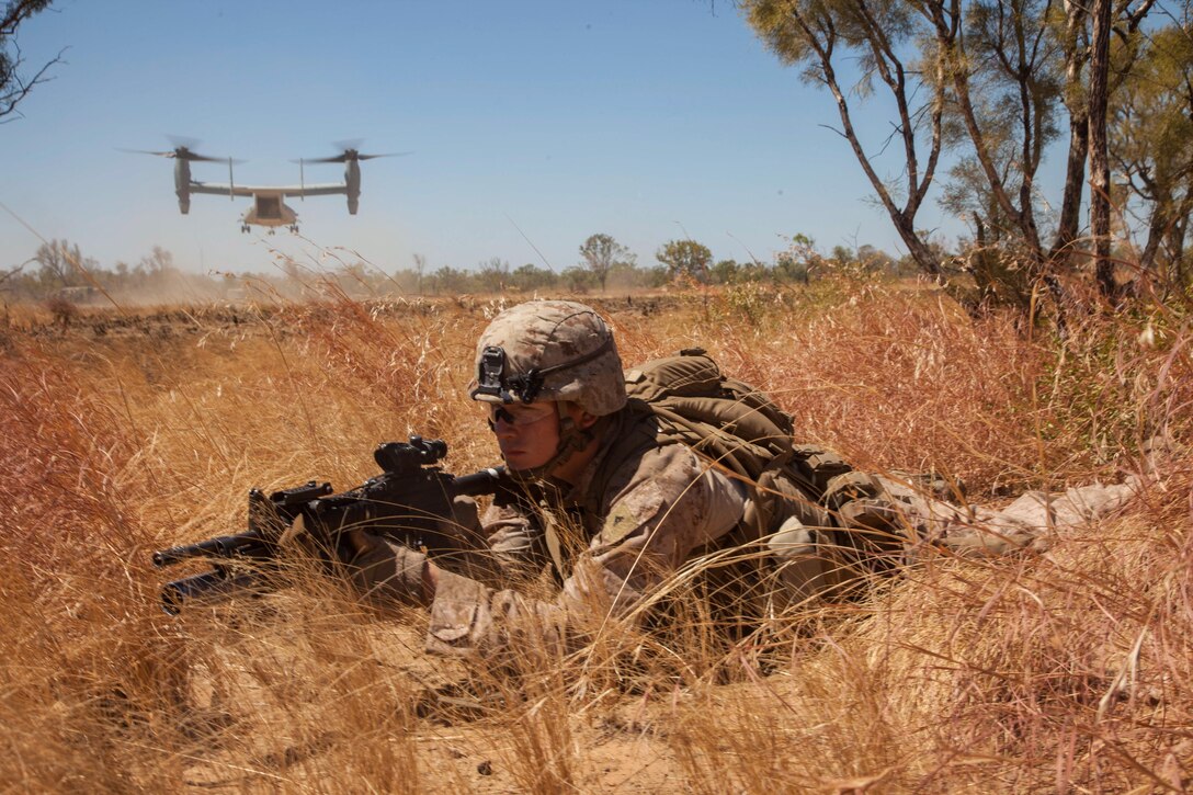 Lance Cpl. John Ready, an M27 Infantry Automatic Rifle gunner for Company E., Battalion Landing Team 2nd Battalion, 4th Marines, 31st Marine Expeditionary Unit, provides security as an MV-22 Osprey from Marine Medium Tiltrotor Squadron 265 (Reinforced), 31st MEU, takes off after inserting a platoon of Marines during a combined, live-fire exercise for Exercise Koolendong 13 here, Sept. 3. The 31st MEU moved a battalion-sized force more than 300 miles inland from the Port of Darwin to conduct training. The exercise demonstrates the operational reach of the 31st MEU. Also participating in the exercise is the Marine Rotational Force – Darwin and soldiers of the 5th Royal Australian Regiment. The 31st MEU brings what it needs to sustain itself to accomplish the mission or to pave the way for follow-on forces. The 31st MEU is the Marine Corps' force in readiness for the Asia-Pacific region and the only continuously forward-deployed MEU. 