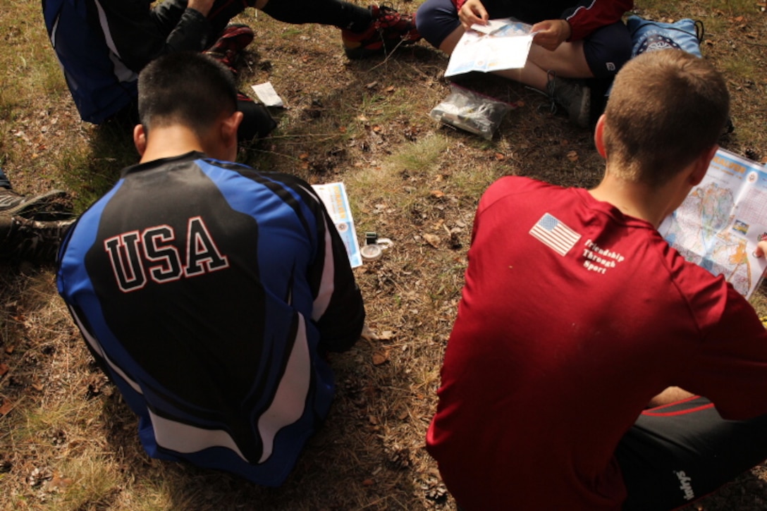 Members of the U.S. Armed Forces review their maps before the middle distance course at the 2013 CISM World Orienteering Military Championship hosted by the Swedish Armed Forces in Eksjo, Sweden from 26 August to 1 September. 