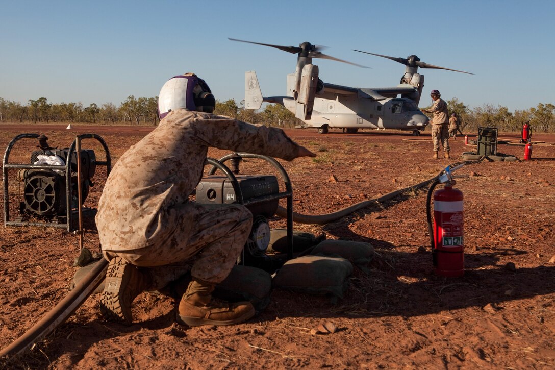 Bulk fuel specialists with Marine Medium Tiltrotor Squadron 265 (Reinforced), 31st Marine Expeditionary Unit, re-fuel an MV-22 Osprey during flight operations in support of Exercise Koolendong 13 here, Sept. 3. VMM-265 (REIN) is supporting a battalion-sized element from an expeditionary airfield more than 300 miles inland from the port of Darwin for the exercise. Koolendong demonstrates the operational reach of the 31st MEU. Also participating in the exercise is the Marine Rotational Force – Darwin and soldiers of the 5th Royal Australian Regiment. The 31st MEU brings what it needs to sustain itself to accomplish the mission or to pave the way for follow-on forces. Marines and Sailors with Company E., Battalion Landing Team 2nd Battalion, 4th Marines, 31st Marine Expeditionary Unit, offload from an MV-22 Osprey with Marine Medium Tiltrotor Squadron 265 (Reinforced), 31st MEU, to participate in Exercise Koolendong 13 here, Aug. 30. The 31st MEU is moving a battalion-sized force more than 300 miles inland from the Port of Darwin to conduct a live-fire training exercise. Also participating in the exercise is the Marine Rotational Force – Darwin and soldiers of the 5th Royal Australian Regiment. The 31st MEU brings what it needs to sustain itself to accomplish the mission or to pave the way for follow-on forces. The 31st MEU is the Marine Corps' force in readiness for the Asia-Pacific region and the only continuously forward-deployed MEU. 