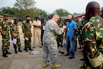 Master Sgt. Derek Gill demonstrates proper use of portable scales with the assistance of an interpreter. Gill and fellow Georgia Army National Guardsman Staff Sgt. Samuel Perez trained more than 30 Burundi soldiers during a two-week Africa Deployment Assistance Partnership Team training known as ADAPT.