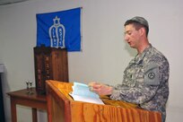 First Lt. David Frommer leads a small group of service members and civilians in the chanting of the Torah. A chaplain of four years, Frommer has conducted several celebrations of the biblical holiday Sukkot (Feast of Booths, Feast of Tabernacles), but this was his first in the Middle East.
