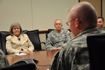 Holly Petraeus, the assistant director at the Consumer Financial Protection Bureau for the Office of Service Member Affairs, sits next to Command Chief Doug Hensala, state command chief for the Wyoming Air National Guard, as they both listen to Maj. Gen. Luke Reiner, adjutant general for Wyoming, during a discussion on potential financial pitfalls for troops, Oct. 4, 2012.