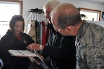 Wisconsin National Guard Challenge Academy Cadet Taelor Davis explains her binder to Dr. Tony Evers, Wisconsin Department of Public Instruction superintendent, and Maj. Gen. Don Dunbar, adjutant general of Wisconsin, during a visit to the Challenge Academy.