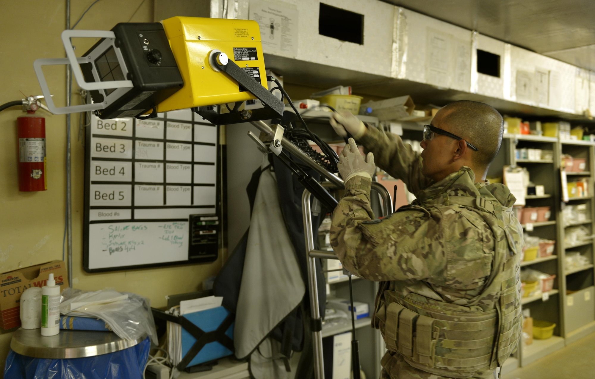 Master Sgt. Ovendalin Brown, Forward Surgical Team medical technician, sets up x-ray equipment in the emergency room on Forward Operating Base Ghazni, August 25, 2013. When Brown is not in the ER treating patients, he is in charge of the 24 Airmen team. Brown is deployed from Luke Air Force Base, Ariz. 