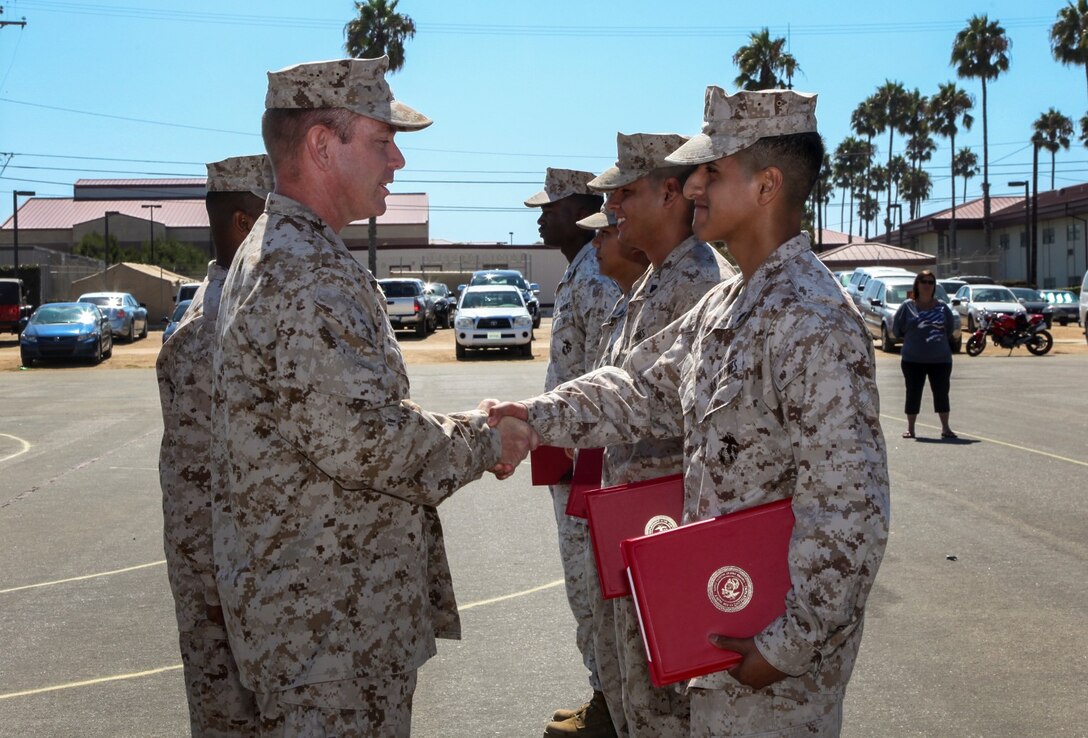 Lance Cpl. Diego Retamozo, administration clerk, Command Element, 15th Marine Expeditionary Unit, shakes hands with Lt. Col. John R. O’Neal, commanding officer, 15th MEU, after being promoted to lance corporal during a promotion ceremony held on the Camp Del Mar Parade Deck aboard Camp Pendleton, Calif., Sept. 3. Retamozo, 20, Perth Amboy, N. J. (U.S. Marine Corps photo by Cpl. Emmanuel Ramos/Released)
