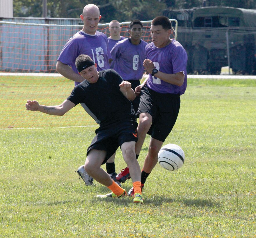 Members of the personnel administration school charge the ball against from the financial management school players during the annual soccer tournament aboard Camp Johnson, Aug. 24.