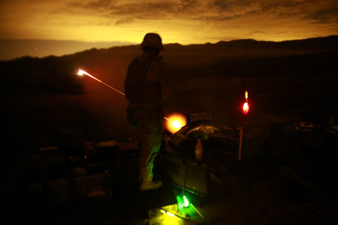Marines serving with Charlie Company, 3rd Assault Amphibian Battalion, fire the .50 caliber machine gun during a live-fire range here, Aug. 27, 2013. The purpose of the range was to give crewmembers of the amphibious assault vehicle a chance to refine their skills with the .50 caliber machine gun, and the 40 mm grenade launcher. The Marines performed the exercise in preparation for their upcoming deployment to Okinawa, Japan, where they will support joint operations in the Pacific.