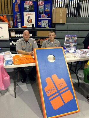 Park Rangers Daniel Clark and Christon Cornett both Park Rangers from the U.S. Army Corps of Engineers Nashville District welcome students from the Laurel County school district to a back to school bash at the Laurel County Optimist complex on July 30, 2013. 