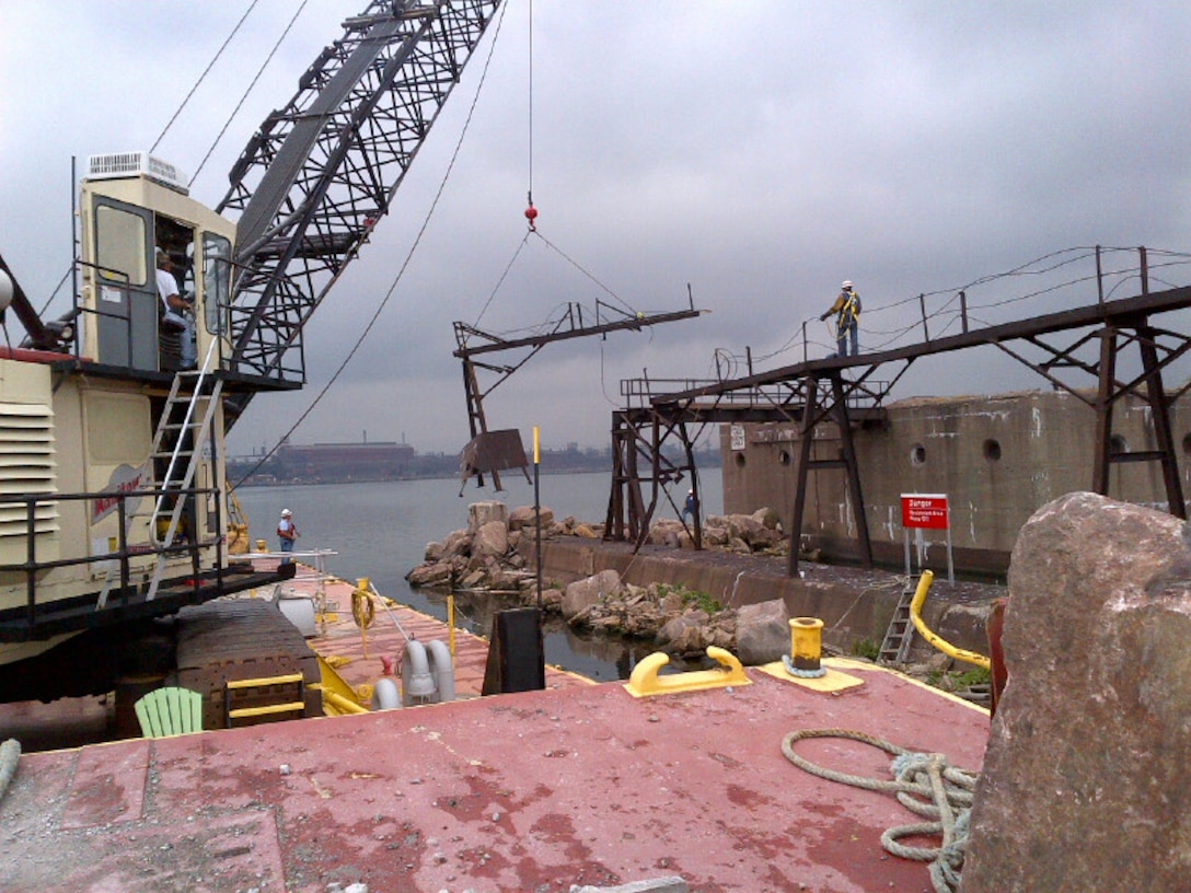 The Manitowoc crane barge removes part of the catwalk structure from the Indiana Harbor pier in East Chicago, Ind.