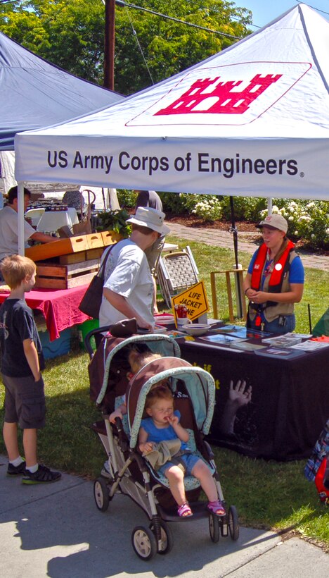 SCA intern Avery Kool is at a Farmer's Market in The Dalles, staffing a water safety booth for the U.S. Army Corps of Engineers, explaining the importance of life jackets and swimming well.