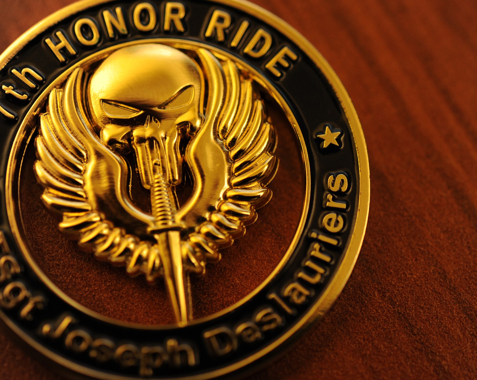 Master Sgt. Joseph Deslaurier was the honoree for the 7th Annual Operation One Voice Honor Ride at Hurlburt field, Fla., Sept. 4, 2013. A challenge coin was made in his honor and given out to key players in the event. (U.S. air Force photo/Staff Sgt. Eboni Reams)