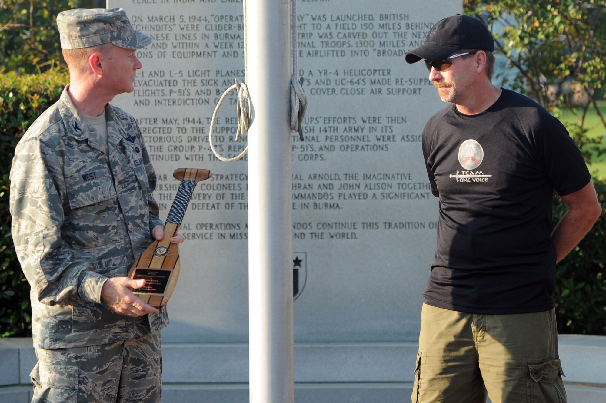 Col. Bill West, the 1st Special Operations Wing commander, accepts an award on behalf of Master Sgt. Deslauriers, explosive ordnance disposal technician with 1st Special Operations Civil Engineer Squadron , from Bill Stevens, representative of Operation One Voice, at the airpark on Hurlburt Field, Fla., Sept. 4, 2013. After the ceremony Operation One Voice began the 7th Annual Honor Ride in honor of Deslauriers, from Hurlburt Field to Duluth, Ga.