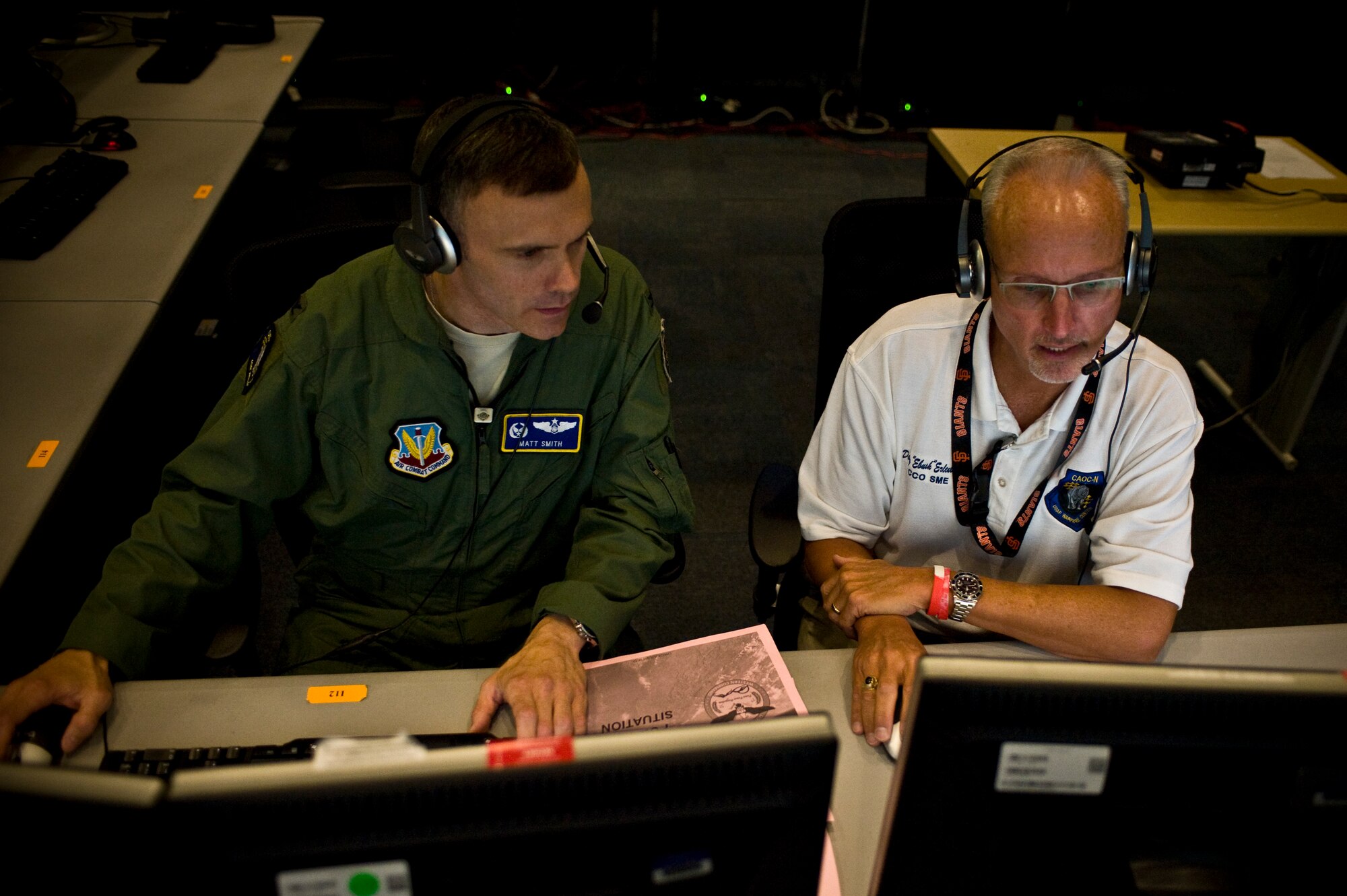Col. Matt Smith, 505th Test and Evaluation Group commander, and Doug Erlenbusch, 505th TS chief of combat operations, discuss aircraft assets during a continuation training exercise Aug. 28, 2013, at Nellis Air Force Base, Nev. An air operations center is the senior command and control element of the Air Force’s Theater Air Control System and is responsible for effectively planning, directing, and executing joint air operations in support of the joint force commander’s operation or campaign objectives. (U.S. Air Force photo by Airman 1st Class Christopher Tam)