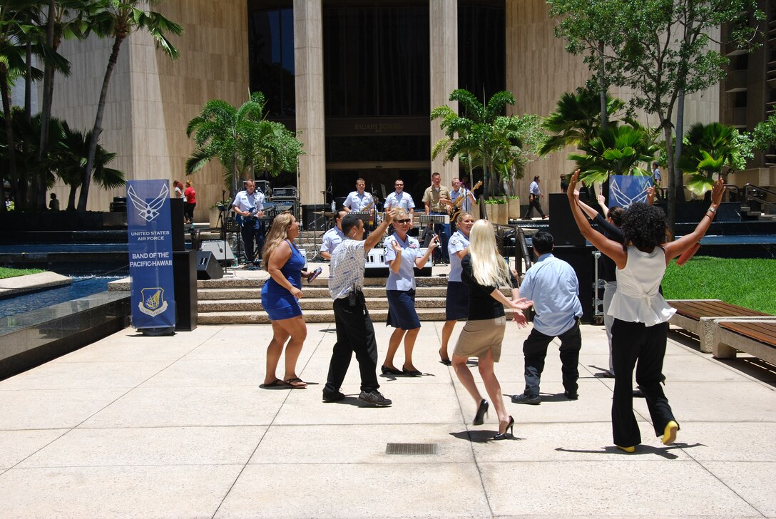 HONOLULU, Hawaii-- Audience members dance while they listen to Hana Hou!, Band of the Pacific-Hawaii, during a performance at Tamarind Park, Aug. 7, 2013.The group performed a lunch-time concert for the thousands of people that work and live in the financial district of Honolulu. 

(US Air Force Photo/Tech. Sgt. Stanley Johnson/released)