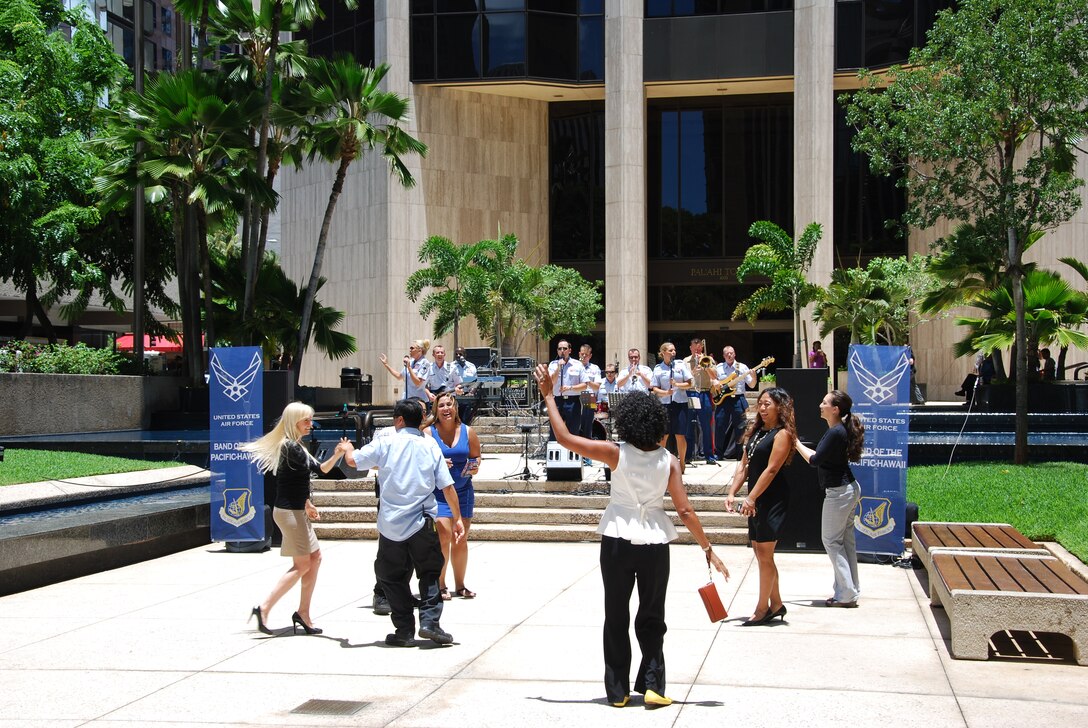 HONOLULU, Hawaii-- Audience members gather to listen to Hana Hou!, Band of the Pacific-Hawaii, as they rock out at Tamarind Park, Aug. 7, 2013.The group performed a lunch-time concert for the thousands of people that work and live in the financial district of Honolulu. 

(US Air Force Photo/Tech. Sgt. Stanley Johnson/released)