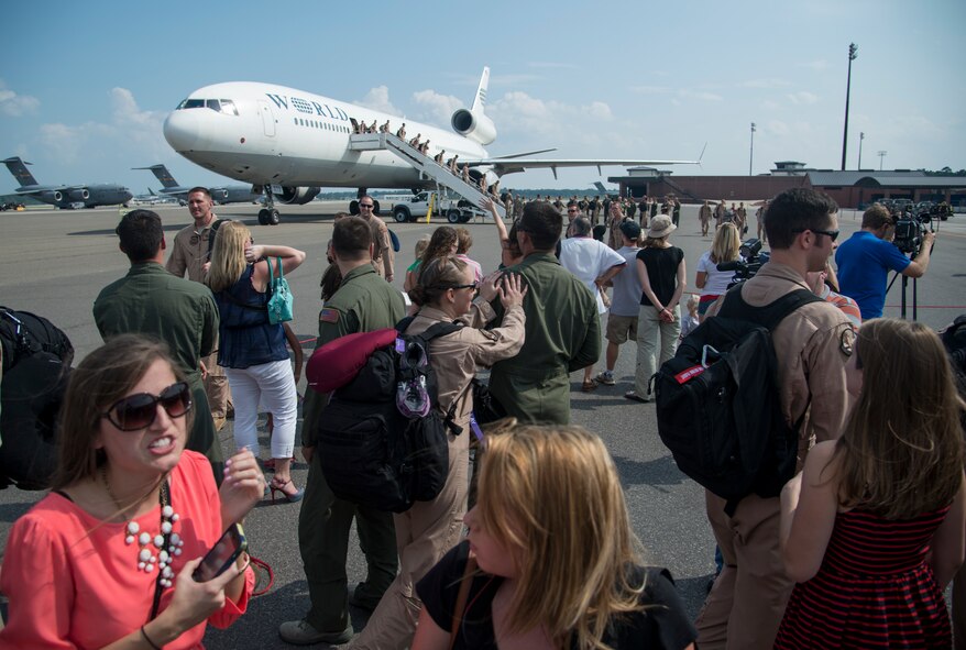17th Airlift Squadron Airmen reunite with their families during the 17th AS redeployment Sept. 3, 2013, at Joint Base Charleston - Air Base, S.C. More than 100 Airmen from the 17th AS returned home from a deployment to Southwest Asia. Flying the C-17 Globemaster III, crews flew and supported roughly 790 sorties, logged more than 1,860 combat flying hours and airlifted more than 19.5 million pounds of cargo. (U.S. Air Force photo/Tech. Sgt. Rasheen Douglas)